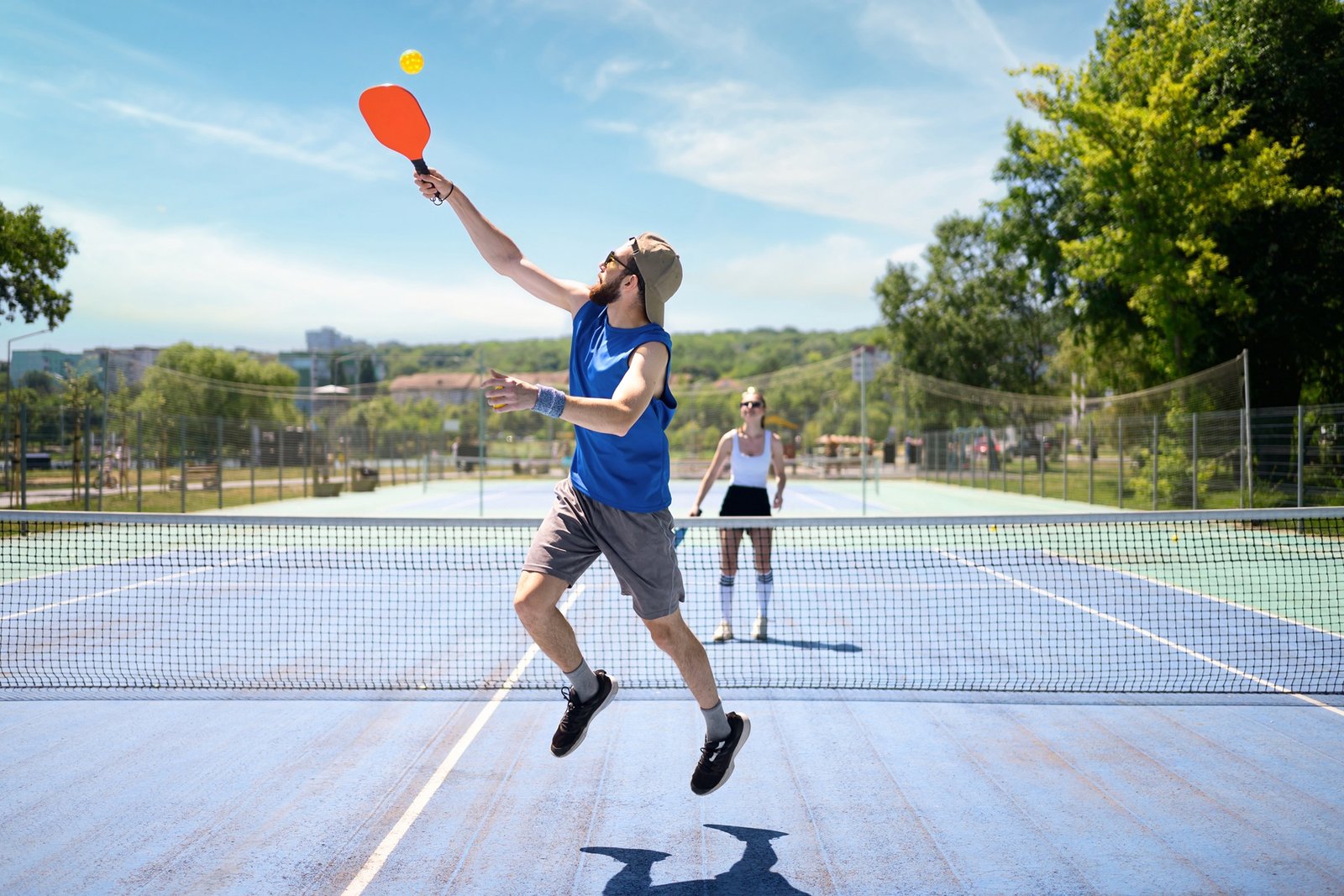 Couple playing pickleball outdoor at daylight