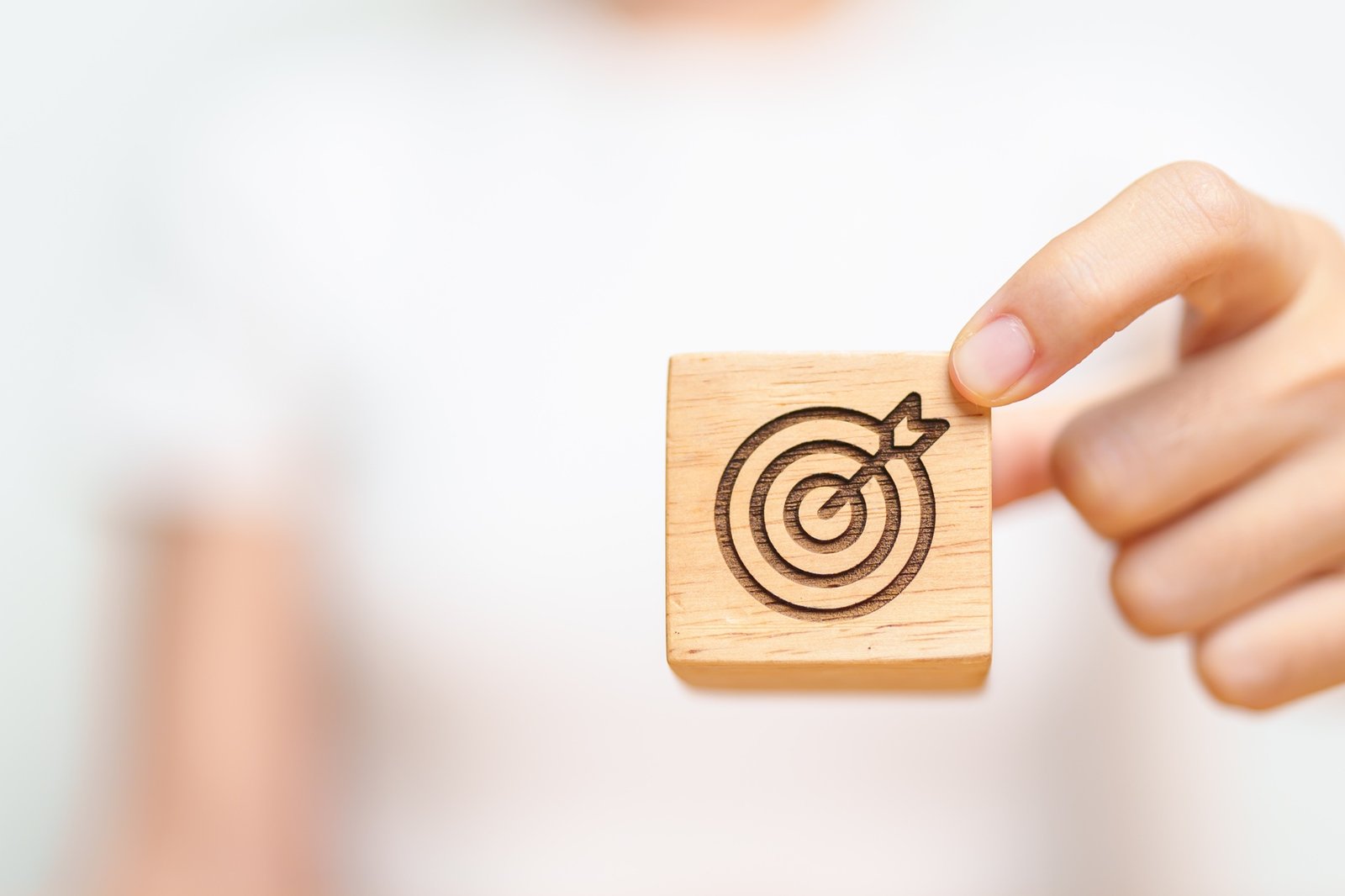 hand hold dartboard block with business goal, strategy, target,